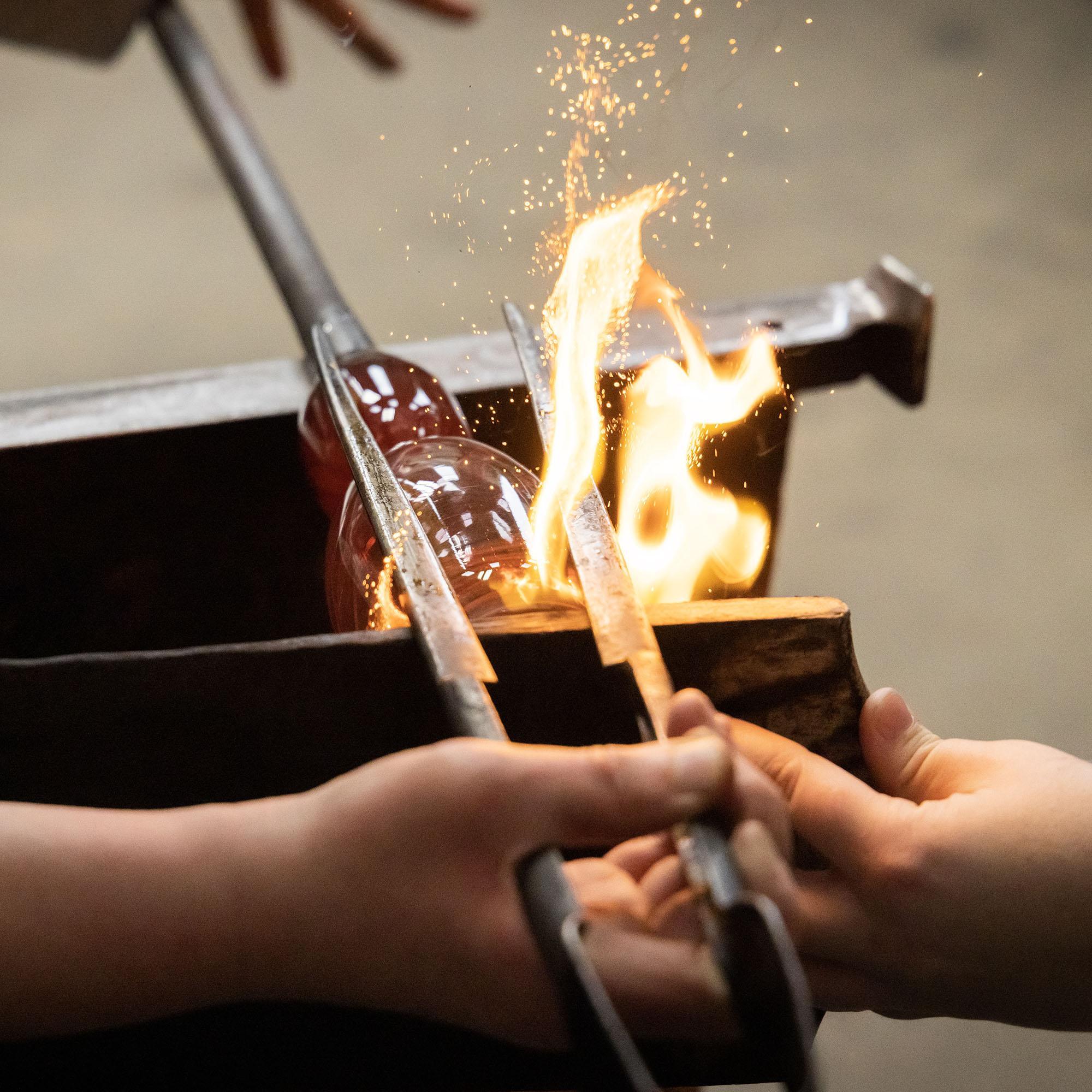 Artists shaping glass. 