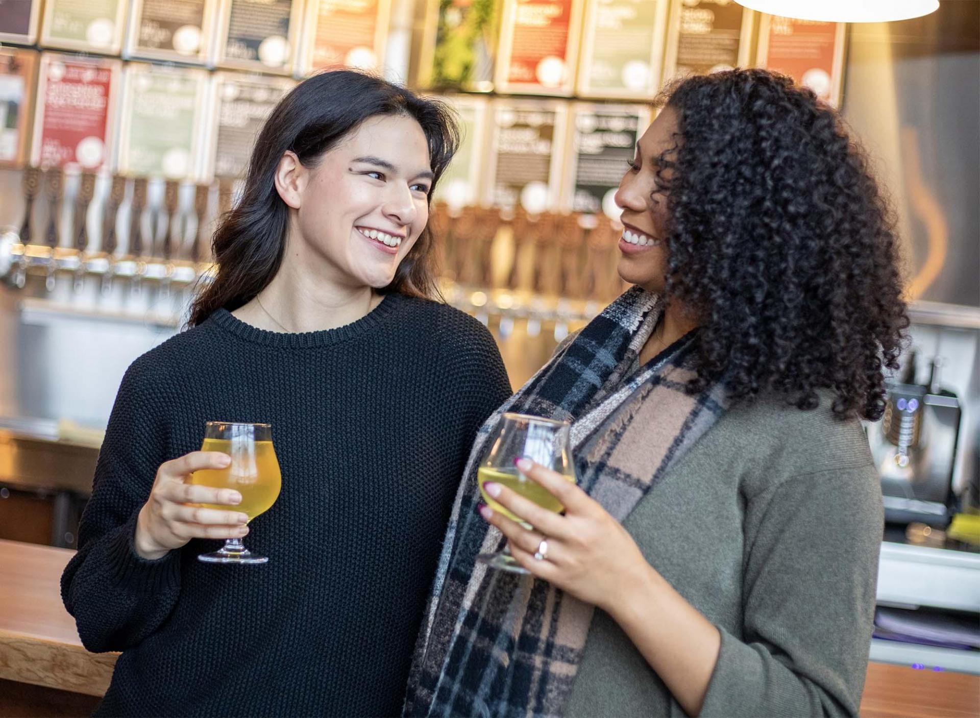 Two people enjoying drinks at River Saint Joe