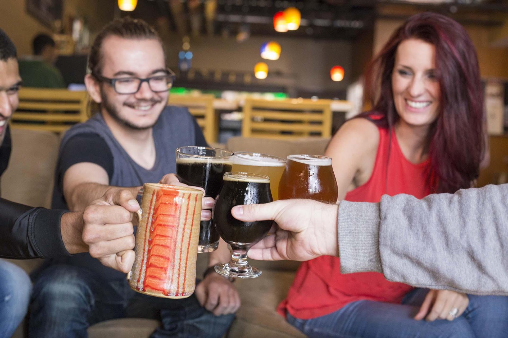 A group of people with drinks at Tapistry Brewing Company.