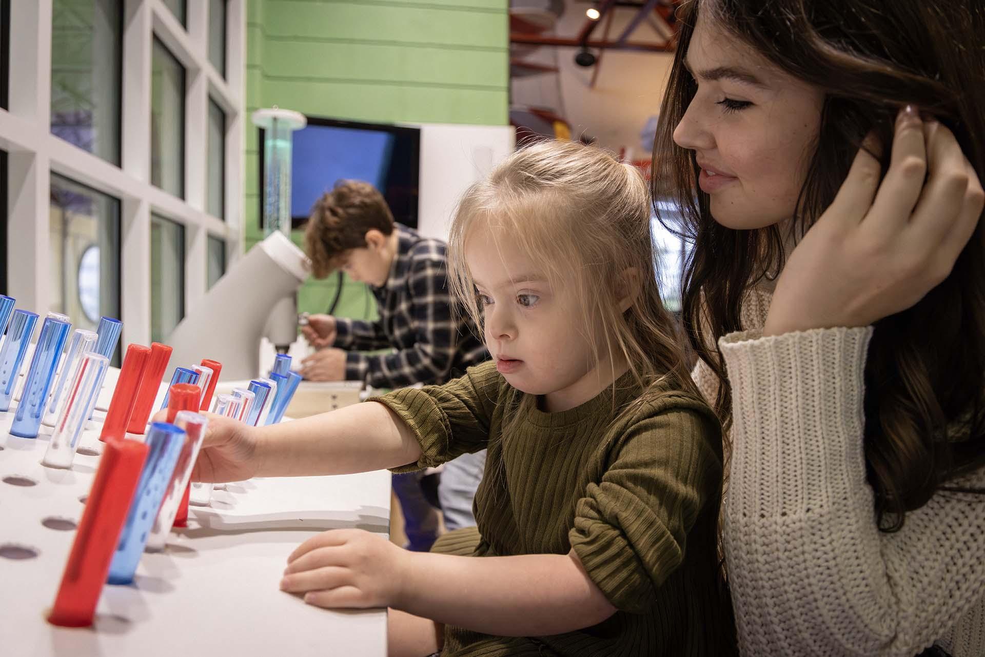 A child interacting with an exhibit at Discovery Zone.