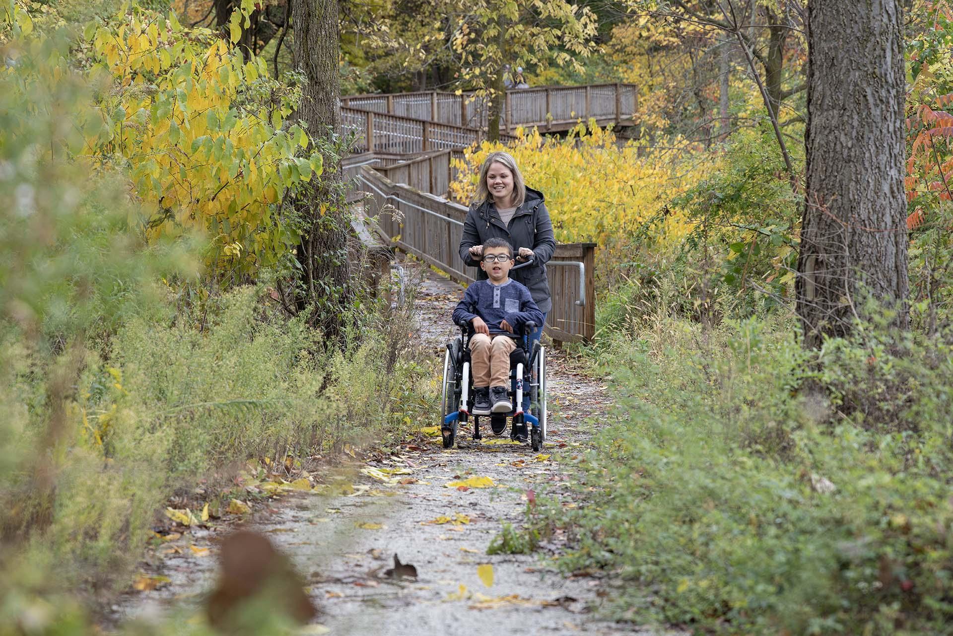 A parent and child on a trail at a park. 