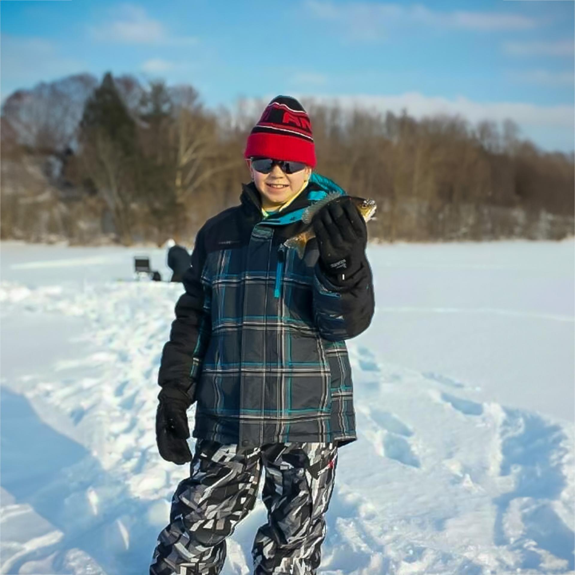 becky son ice fishing child holding a fish