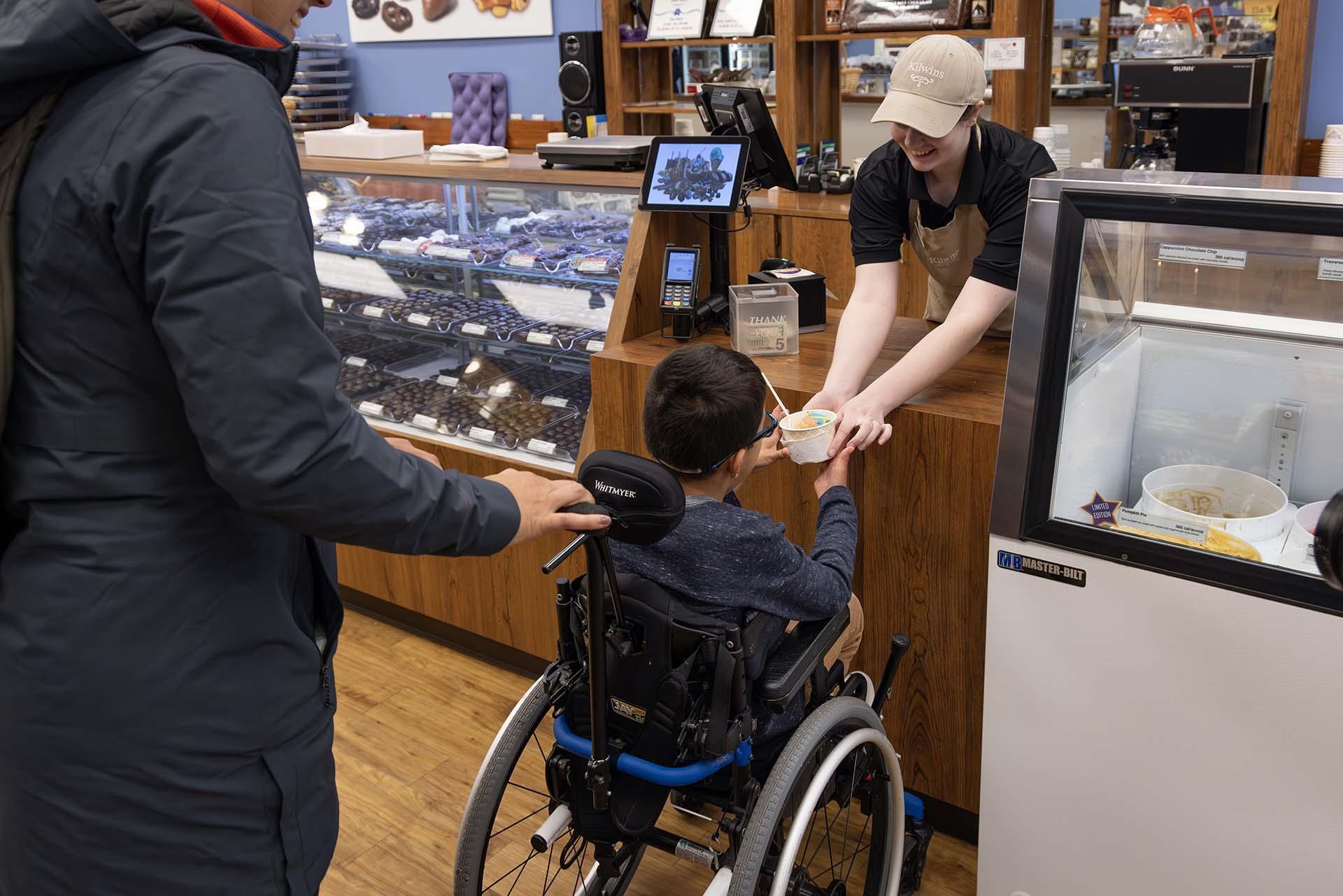 A child being served ice cream at Kilwins.