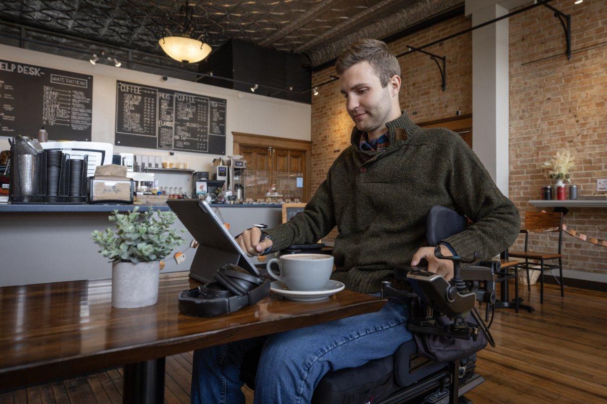 a man looking through a tablet in a coffee cafe