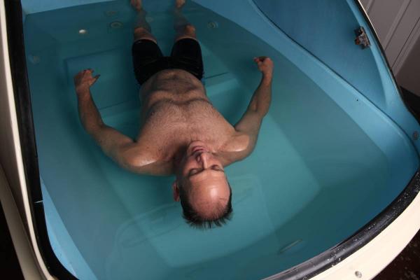 Man floating in a sensory deprivation floatation tank