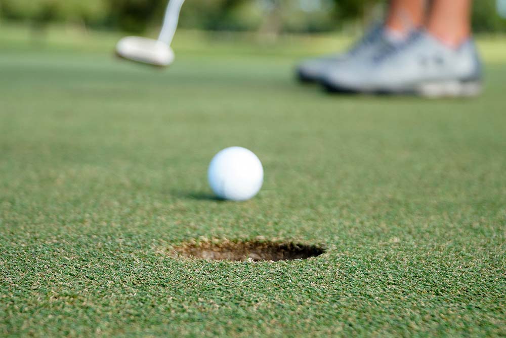 a golfer putting