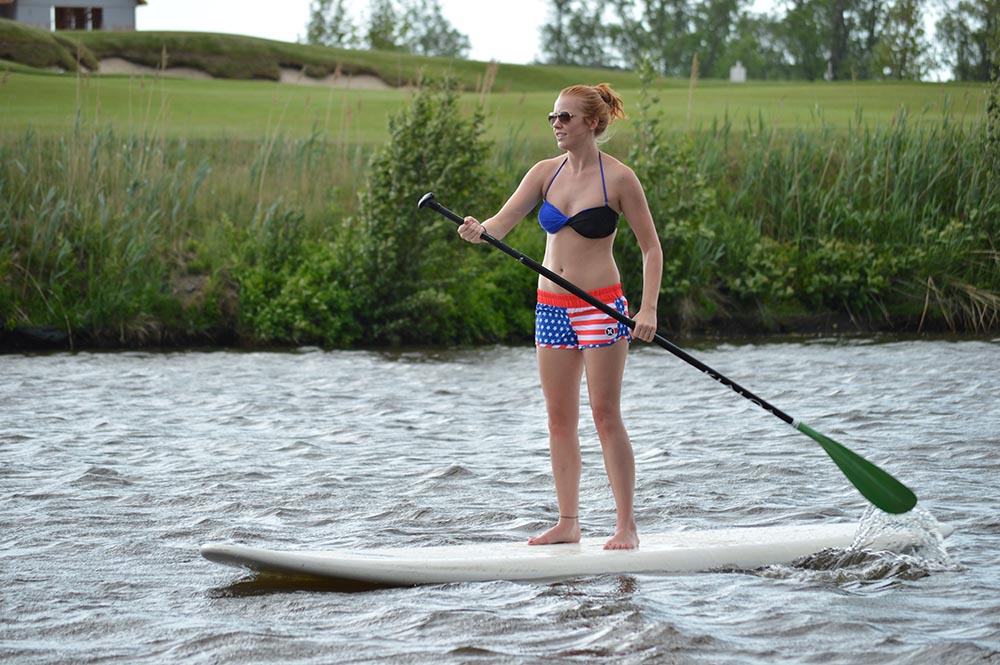 Woman Paddleboarding St. Joe River Woman paddle boarding along the St. Joseph river.